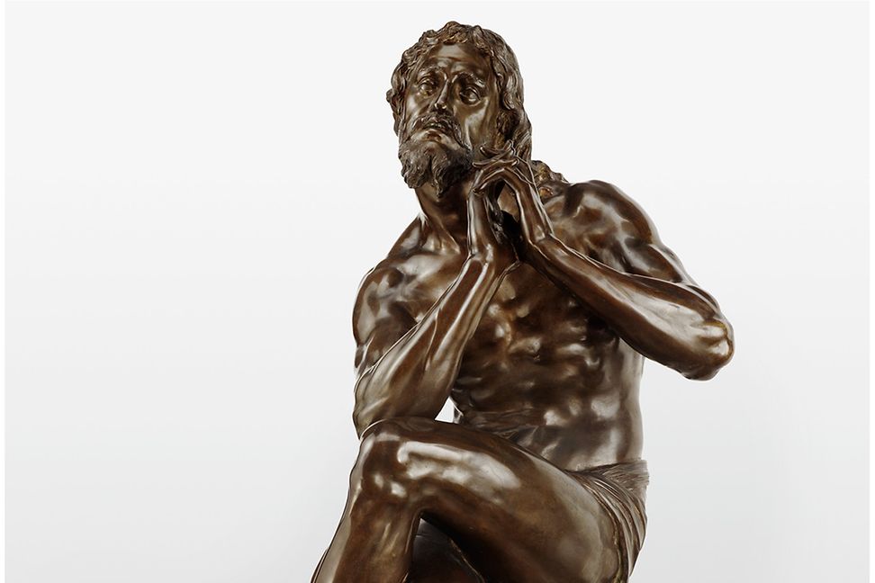 Statue of man sitting in distress