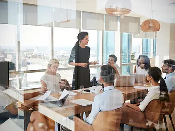group of people around table in boardroom 