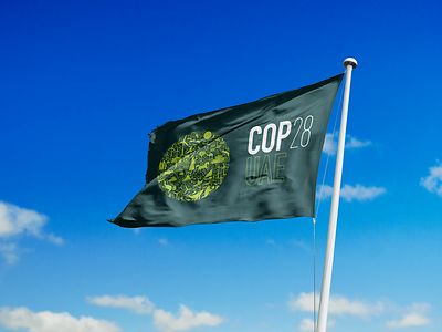 Cop 28 flag on blue sky