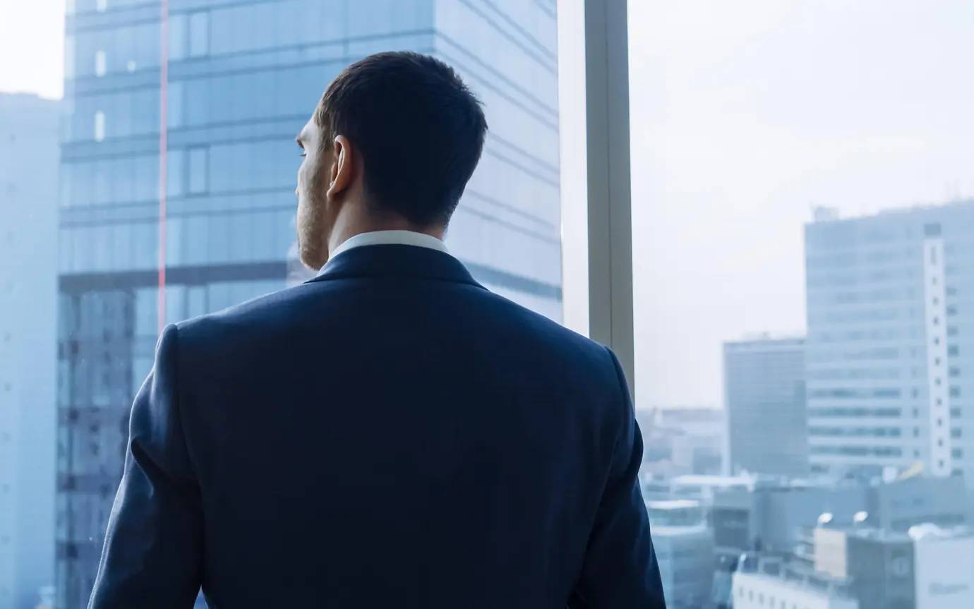 business man looking out of window