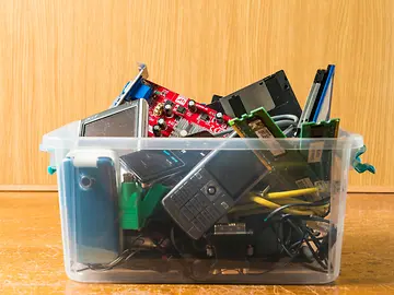 box of old phones and tech