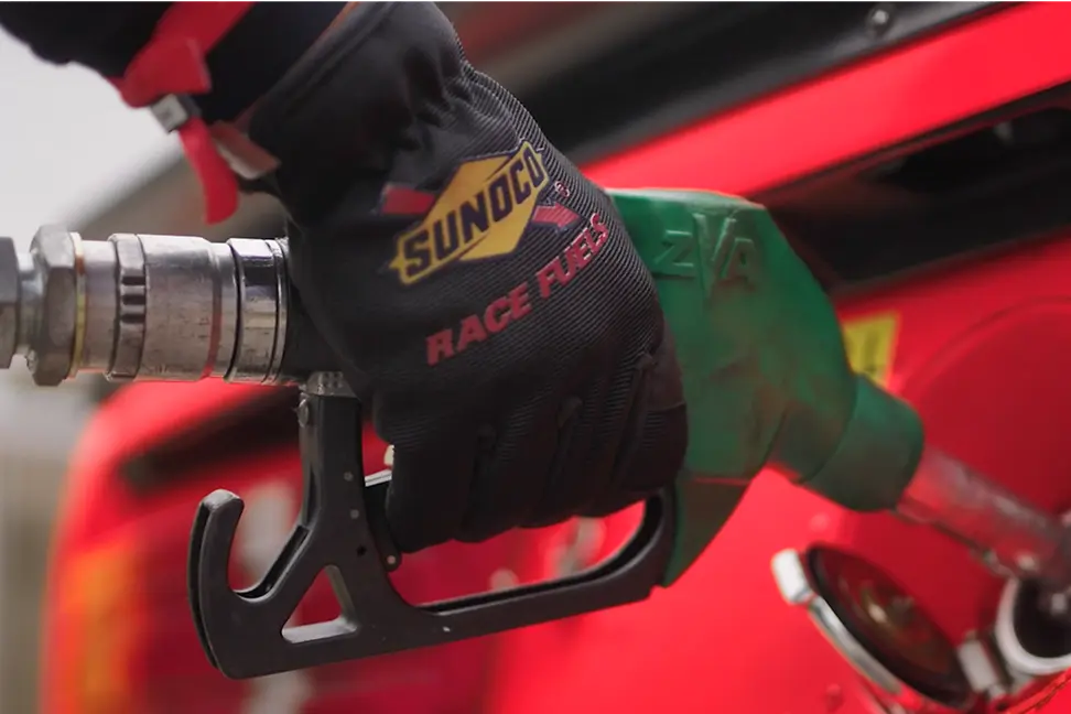 racing driver refuelling a race car