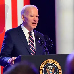 Joe Biden giving a speech from behind a lecturn 