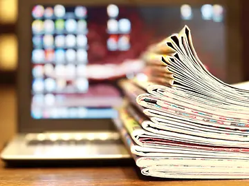 Magazines and Open Laptop