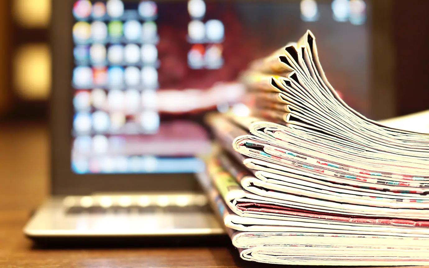 Magazines and Open Laptop