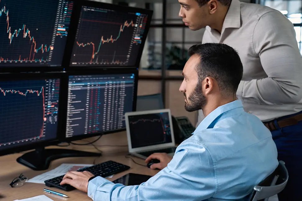 Two confident stock broker looking at screen