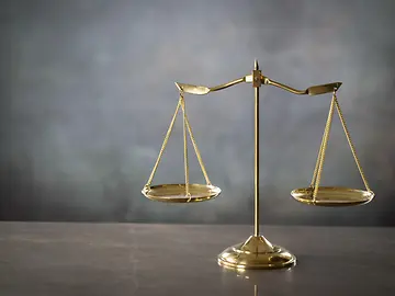 gold justice scale, dark background