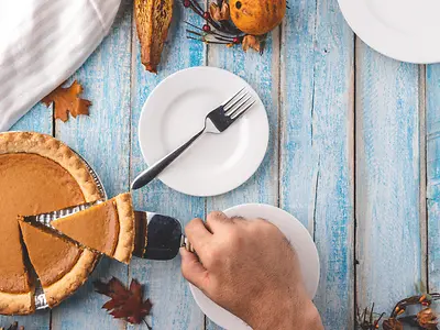 Cutting into a slice of pumpkin pie