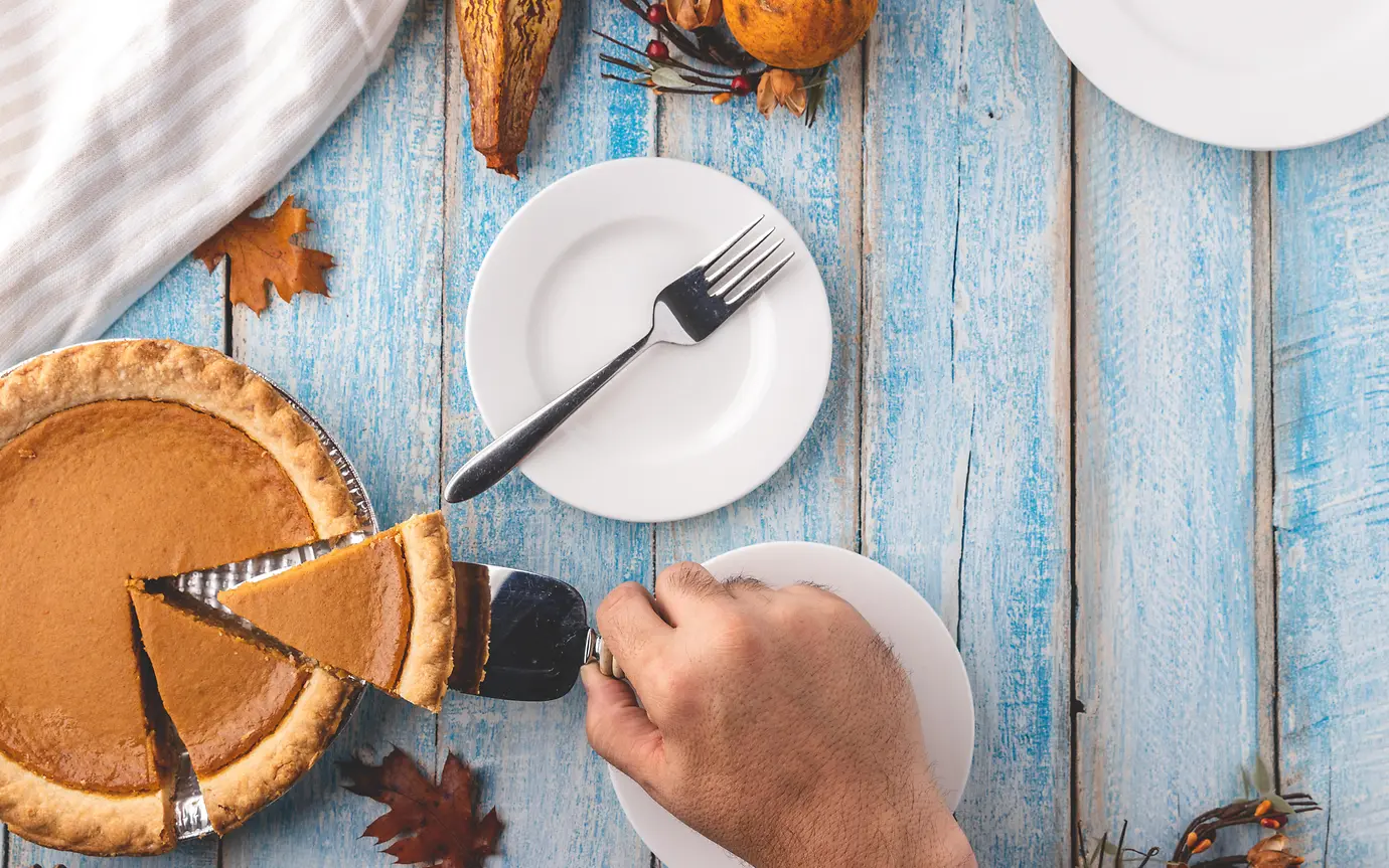 Cutting into a slice of pumpkin pie
