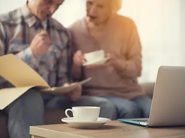 Elderly couple look over documents 