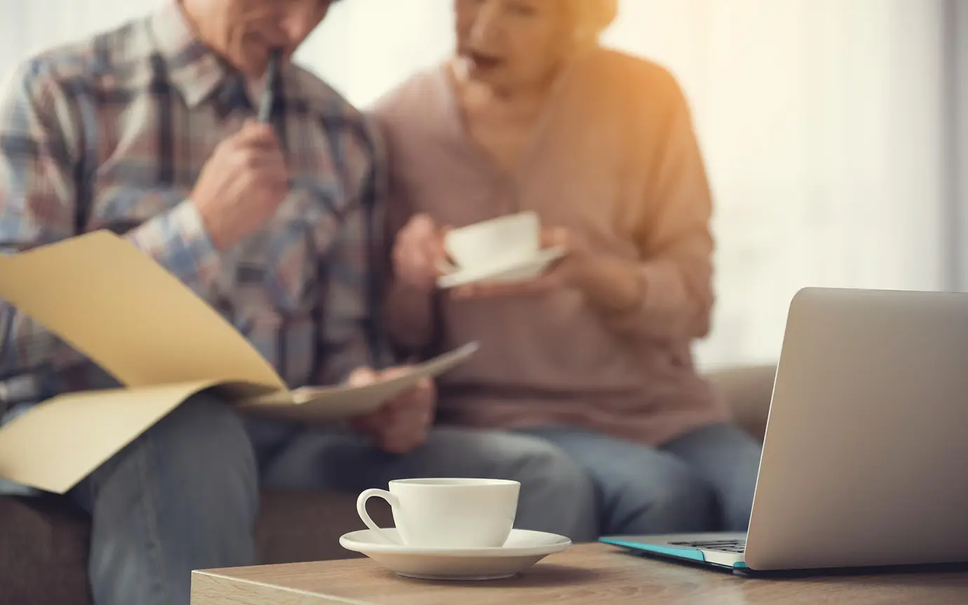 Elderly couple look over documents 