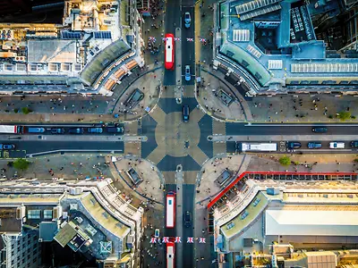  Oxford Circus area, with busy roads, classic buildings, and red buses.