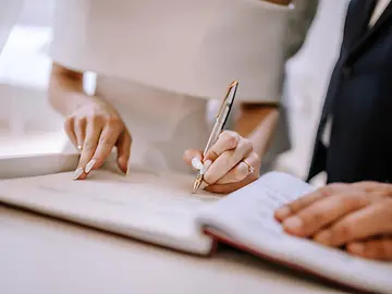 Bridge and groom signing marriage contract 