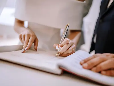 Bridge and groom signing marriage contract 