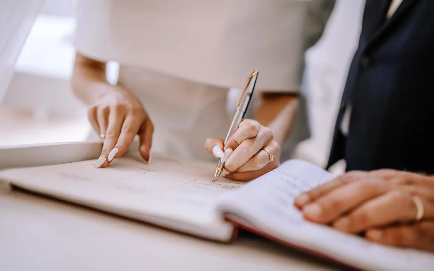 Bridge and groom signing marriage contract 