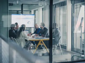 Business Team Meets in a Glass Conference Room