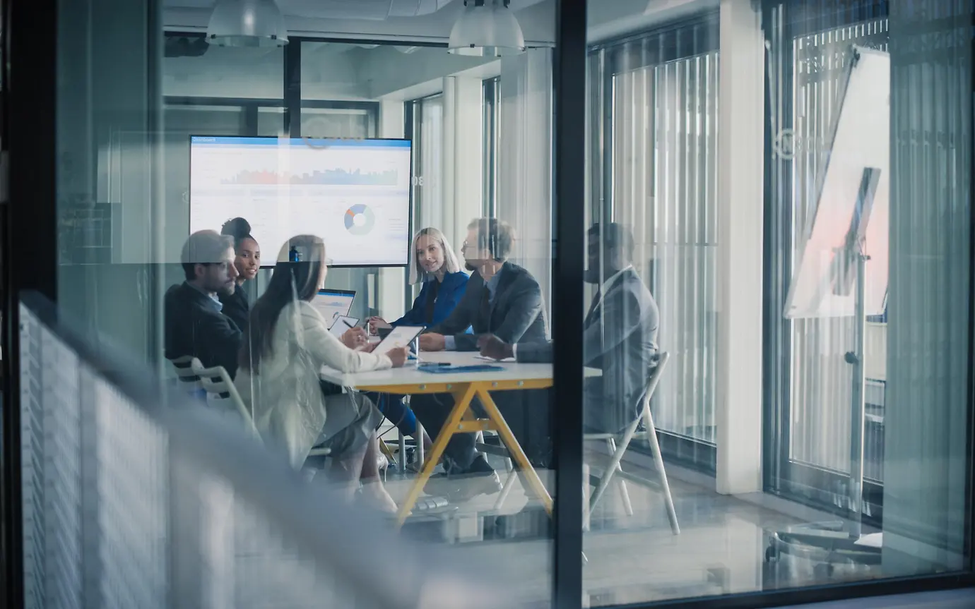 Business Team Meets in a Glass Conference Room