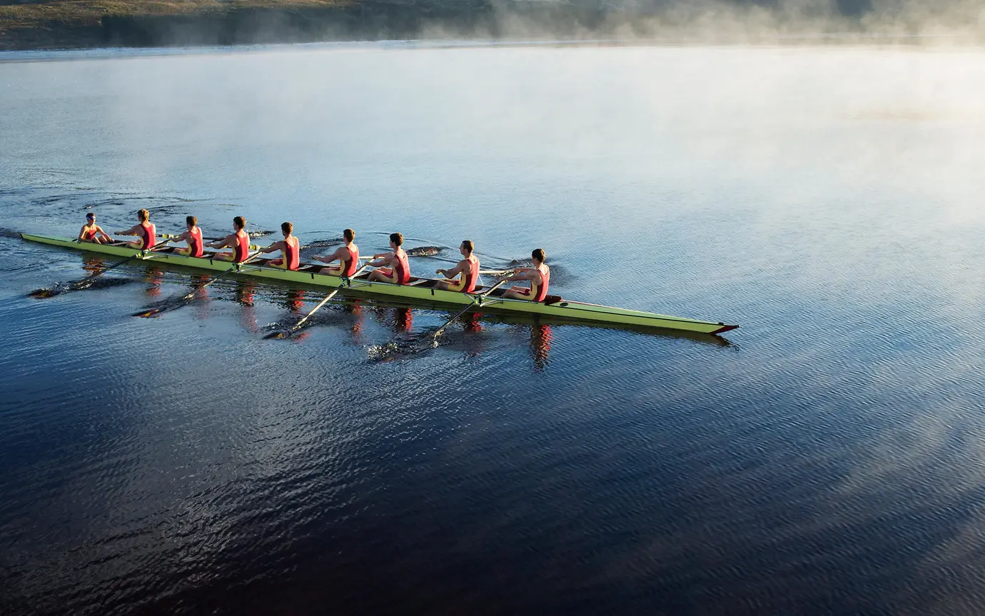 Rowing crew on lake